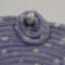 This shows a closeup of the circles with the bead. It also shows some of the frayed raw edges of the fabric adding to its charm.